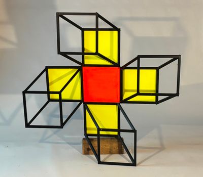 an image of a cross made out of cubes on a wooden stand