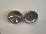two metal knobs that are on a white surface