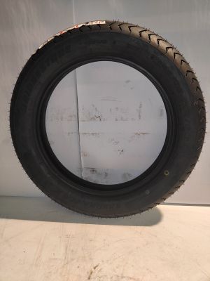a close up of a tire on a white surface with a white wall in the background