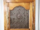 a wooden cabinet with a metal door on top of it