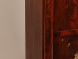 a small chest of drawers with a marble top