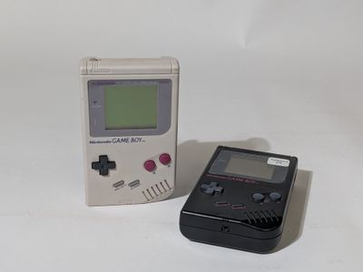 a small gameboy next to a smaller gameboy