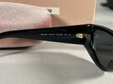 black sunglasses with gold details on the temples and arms