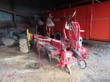 an image of a tractor that is parked in a barn