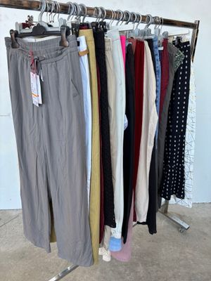 a lot of pants hanging on a rack in a room