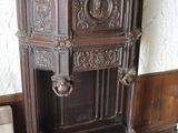 a wooden cabinet with a vase on top of it
