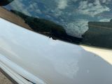 a close up of a car window with the reflection of the sky in the window