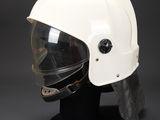 a close up of a helmet on a stand on a black background
