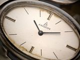 a close up of a wrist watch with roman numerals on it