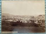 an old photo of a view of a city from a hill