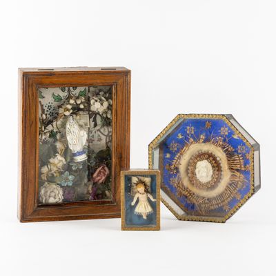 two framed pictures of a child and a picture of a woman