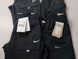 a pair of black pants with tags on them sitting on a table