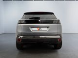 the rear end of a silver suv parked in a garage