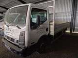 a white truck that is parked in a garage