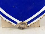 a blue and white heart shaped sign on a wooden stand