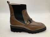 a close up of a pair of brown boots on a white surface