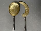 two spoons and a spoon with a gold coin on them