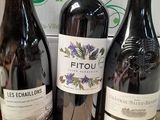 three bottles of wine are sitting on a table in front of a box