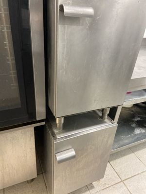 two stainless steel refrigerators in a kitchen next to each other
