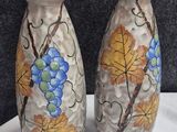 two vases that are sitting on a table