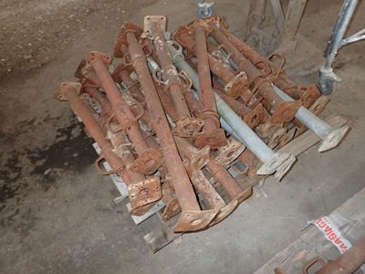 a pile of rusted pipes sitting on a pallet