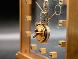 a gold clock that is sitting on a table