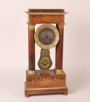 a clock that is sitting on top of a wooden stand
