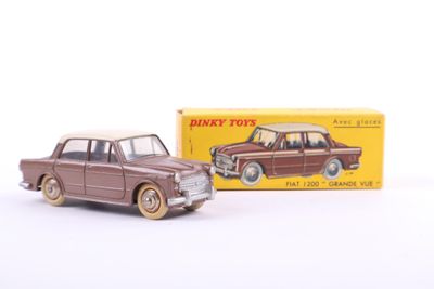 toy car in front of a box of toys on a white surface