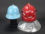 two helmets that are next to each other on a table