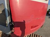 a close up of a red and white train on the tracks