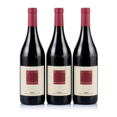 three bottles of red wine sitting next to each other on a white surface