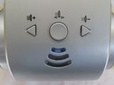 a silver toaster with buttons on it sitting on a table
