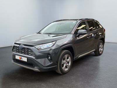 a grey toyota rav parked in a room with a black floor
