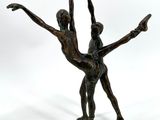 bronze statue of a couple of dancers on a white background