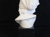 a white marble bust of a woman with a veil on her head