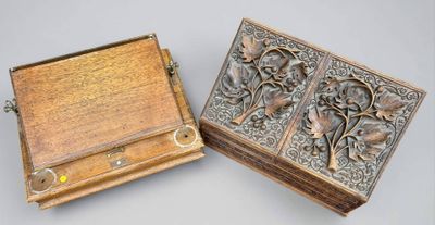 two wooden boxes with carvings on them sitting next to each other
