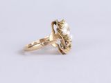 a close up of a gold ring with pearls on it