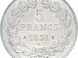 a close up of a silver coin with a wreath on it
