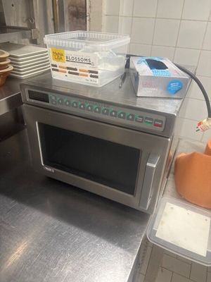 a microwave that is sitting on a counter in a kitchen
