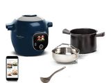 a blue and white rice cooker with a spoon and a cell phone next to it