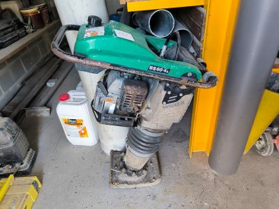 une soufflette verte posée sur un tas d'outils
