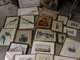 a lot of framed pictures on the floor of a room