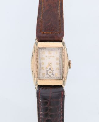 une image d'une montre-bracelet avec un bracelet en cuir marron