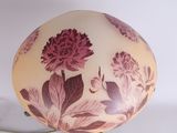 a lamp that is sitting on a table with flowers on it