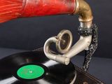 an old record player with a red horn on top of it