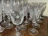 a lot of wine glasses sitting on a wooden table
