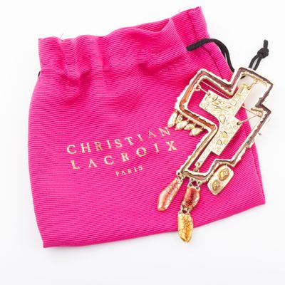 christian lacrox pink bag with a gold cross charm and a pink bag with a gold cross charm on it
