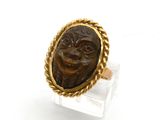 un gros plan d'une bague sur laquelle est représenté un visage