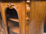 a wooden cabinet that has a glass door on it