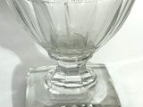 a glass bowl with a flower in it sitting on a table